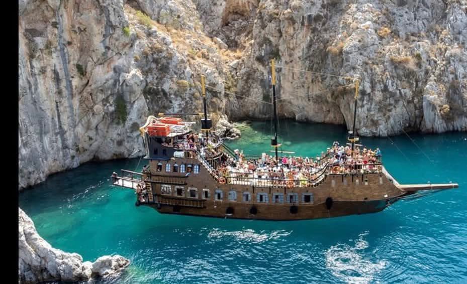Kos daily boat tour cruising through the crystal-clear Aegean Sea with scenic coastlines, swimming stops, and beautiful Greek island views.